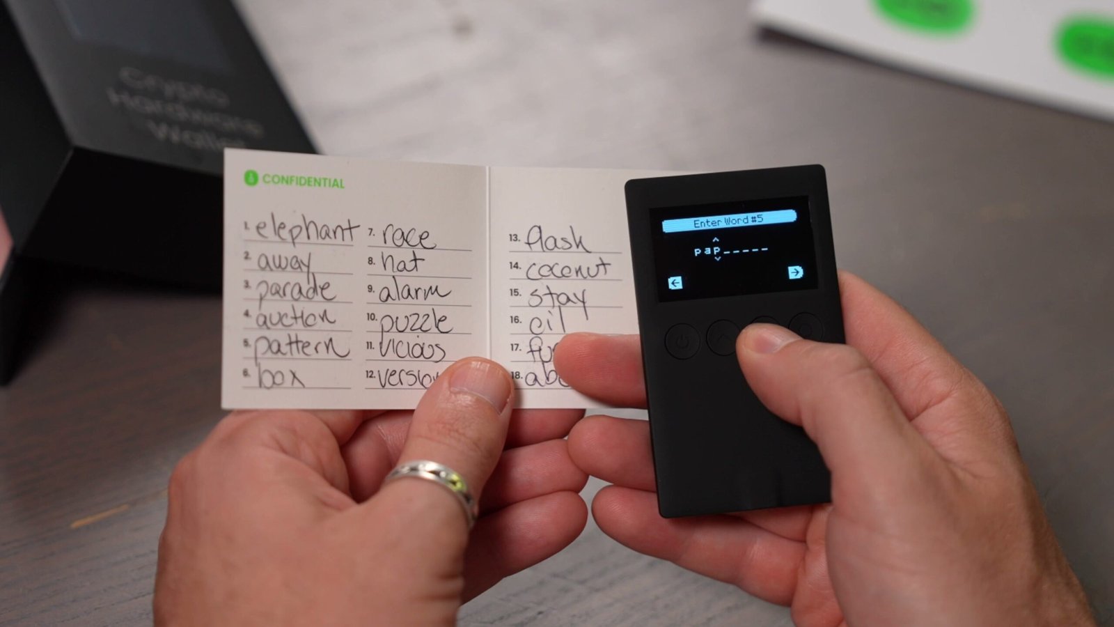 Recovery phrase card next to OneKey hardware wallet